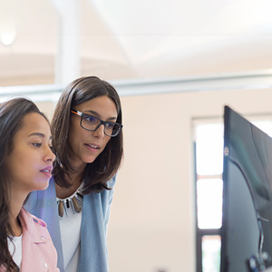 Two women working on a computer