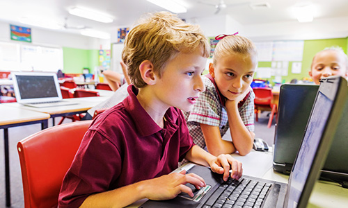 young students using HP mobile device in classroom