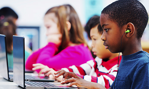 young students all using windows devices in the classroom
