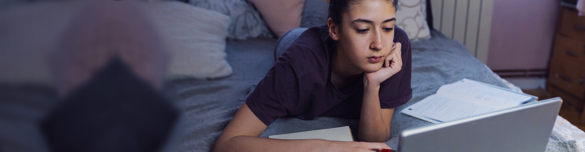 Teenage girl using a laptop learning from home