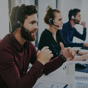 Young male student using headset in classroom
