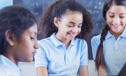 Teacher with iPad and students
