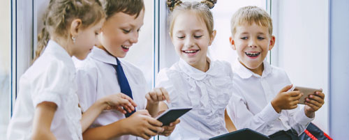 primary children with tablet devices