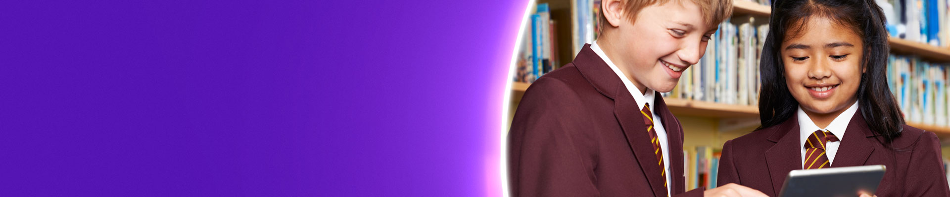 Pupils in library using tablet device